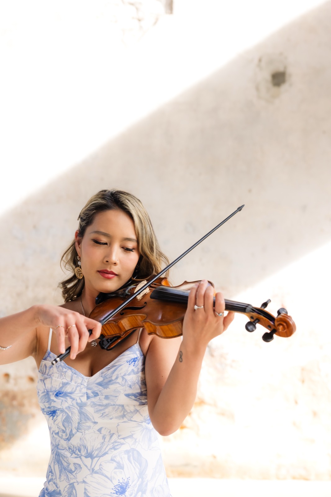 Violinist portrait in a blue floral dress at a Honey I Styled editorial